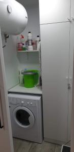 a kitchen with a washing machine and a white refrigerator at Reformado Apartamento - Centro Alicante in Alicante