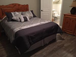 a bedroom with a large bed with pillows on it at Condo Lac Archambault 316 in Saint-Donat-de-Montcalm