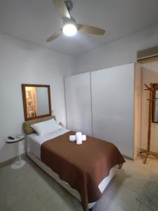 a bedroom with a bed and a ceiling fan at Cozy Studio in Athens