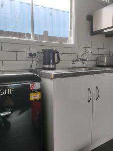 a kitchen with a sink and a counter top at The Avenue in Whanganui