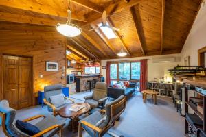 a living room with a couch and chairs and a table at Falls Lodge - a Blue Mountains experience in Wentworth Falls