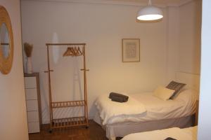 a bedroom with two beds and a mirror at Apartamentos La Herradura PLaza in Haro