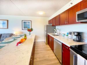 a kitchen with a counter with fruit on it at Mountain View Getaway, Free Parking and Beach Steps Away in Honolulu