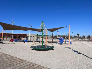 a playground on the beach with a large tent at Genial Casa en Bahía Inglesa in Bahia Inglesa