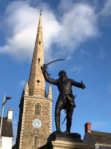 una estatua frente a una torre de reloj en Central Lisburn Duplex Apartment Siren Stays, en Lisburn