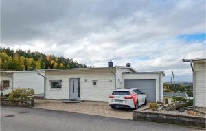 a car parked in front of a house at Nice Home In Uddevalla With Wifi And 3 Bedrooms in Uddevalla