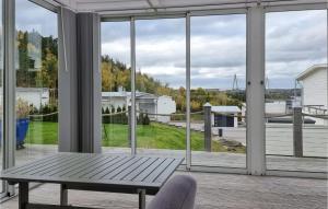 a room with a window and a bench on a porch at Nice Home In Uddevalla With Wifi And 3 Bedrooms in Uddevalla
