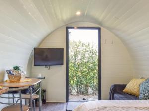 a room with a bed and a table and a window at Privet Pod - Uk41394 in Westhead