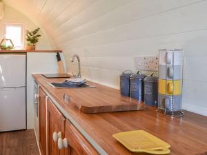 a kitchen with a wooden counter top with a refrigerator at Privet Pod - Uk41394 in Westhead