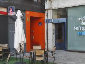 un groupe de chaises et une robe sur le côté du bâtiment dans l'établissement Cordón 4, à Burgos