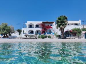 a view of a house from the water at Family house by the seaside of Karavostasis in Karavostasi