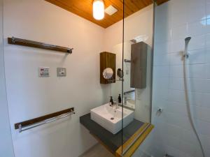 a bathroom with a sink and a shower at Sakura Apartments in Kutchan +20 photos