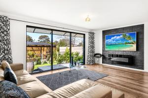 a living room with a couch and a fireplace at Miss B Haven in Cowes