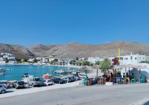 a parking lot with cars parked next to a body of water at Family house by the seaside of Karavostasis in Karavostasi