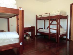 a room with three bunk beds in a room at HI Vila Nova de Foz Coa - Pousada de Juventude in Vila Nova de Foz Coa