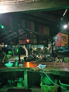 um grupo de pessoas em uma cozinha à noite em koh mook oyoy reggaebar bungalow em Ko Mook