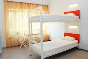 a bedroom with two bunk beds and a table at Hi Espinho - Pousada de Juventude in Espinho