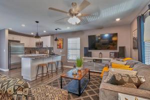a living room with a couch and a kitchen at Cozy Haven Attached to Million Home - South Tampa in Tampa