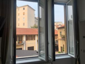 an open window with a view of a building at Ripa150 - Smart Apartament Milano in Milan