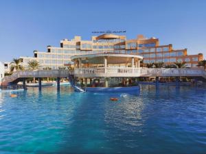 a hotel with a slide in the water in front of it at Al Salam Grand Hotel in Al Buraymī