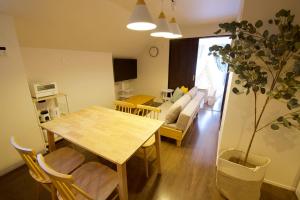a kitchen and living room with a table and a plant at ヒルトップ箱根入生田201 in Yumoto