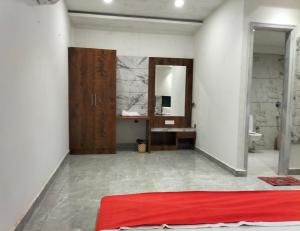 a room with a red bed and a bathroom at Hotel Delight Inn, Amritsar in Amritsar