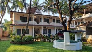 a house with a garden in front of it at Garden Villa in Vagator