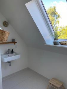 a bathroom with a sink and a window at Hjortholms Bistro nr 1 in Vallebo