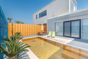 a house with a swimming pool next to a building at Boutique Pool Villa NAMIB in Jeju