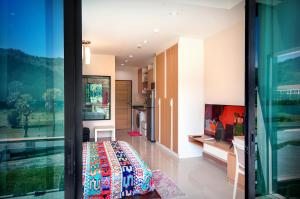 a room with a bed and a glass door at Nai Thon Condo Unit in Nai Thon Beach