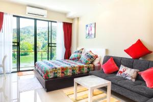 a living room with a couch and a table at Nai Thon Condo Unit in Nai Thon Beach