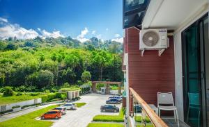 a balcony with cars parked in a parking lot at Nai Thon Condo Unit in Nai Thon Beach