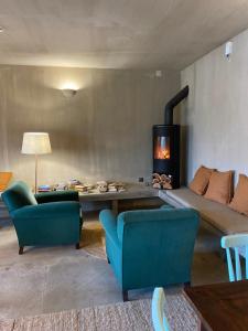 a living room with a couch and a fireplace at Azenhas do Mar Valley House in Sintra