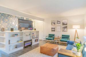 a living room with a tv and two chairs at Taku's Contemporary & Stylish Private Retreat in Fairbanks