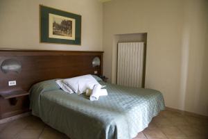 a bedroom with a bed with two towels on it at Albergo Reale in Roccaraso