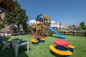a playground with a slide and play equipment at Gaia Village in Tigaki