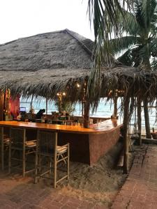 a restaurant on the beach with a table and chairs at doublep in Ban Phlong Sawai