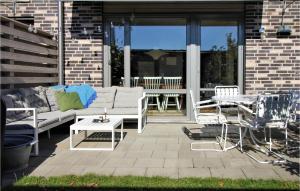 a patio with a couch and a table and chairs at 4 Bedroom Nice Home In Limhamn in Malmö