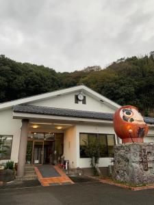 a building with a large pumpkin in front of it at 民宿ニュー万福茶屋 in Taketa