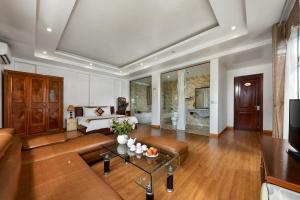 a living room with a couch and a table at Airport Transit Hotel in Hanoi