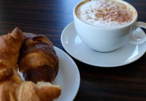 a cup of coffee and a pastry on a table at Dimora Ketty in Noci