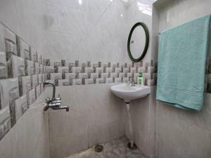 a bathroom with a sink and a mirror at Comfy 2-bedroom House in Sanjaynagar, Bengaluru in Bengaluru