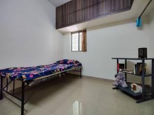 a room with two bunk beds and a shelf at Comfy 2-bedroom House in Sanjaynagar, Bengaluru in Bengaluru