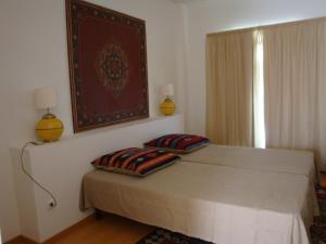 a bedroom with a bed with two pillows on it at HI Tavira – Pousada de Juventude in Tavira +34 photos