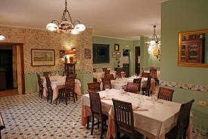 a dining room with tables and chairs in a restaurant at Locanda il Fienile in Naples