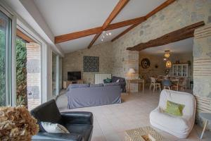 a living room with a couch and a table at Gite de Micouleau in Nérac