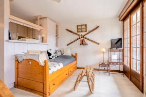a bedroom with a wooden bed with a large clock on the wall at Constellation 012 in Verbier