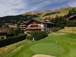 an aerial view of a golf course with a resort at Constellation 012 in Verbier