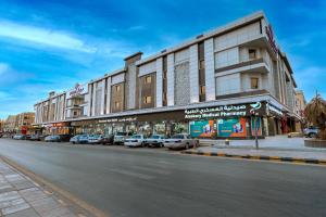 a street with cars parked in front of a building at Boudl Al Sulimanyah in Riyadh