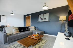 uma sala de estar com um sofá e uma mesa em City Centre Apartment with Free Parking, Balcony, Super-Fast Wifi and Smart TV with Netflix by Yoko Property em Northampton